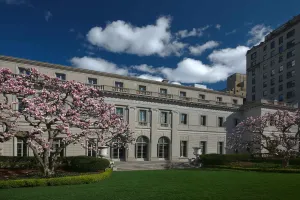 exterior image of Frick Building with magnolia trees in bloom