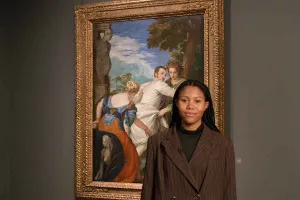 woman standing in front of painting in gallery